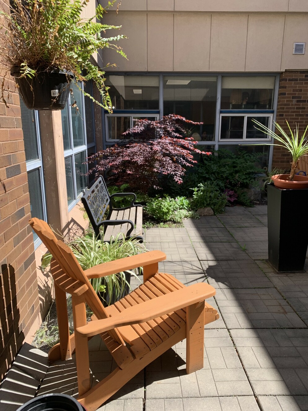 Picture of a chair and bench in an area with flowers
