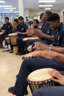 Group of students playing the bongos